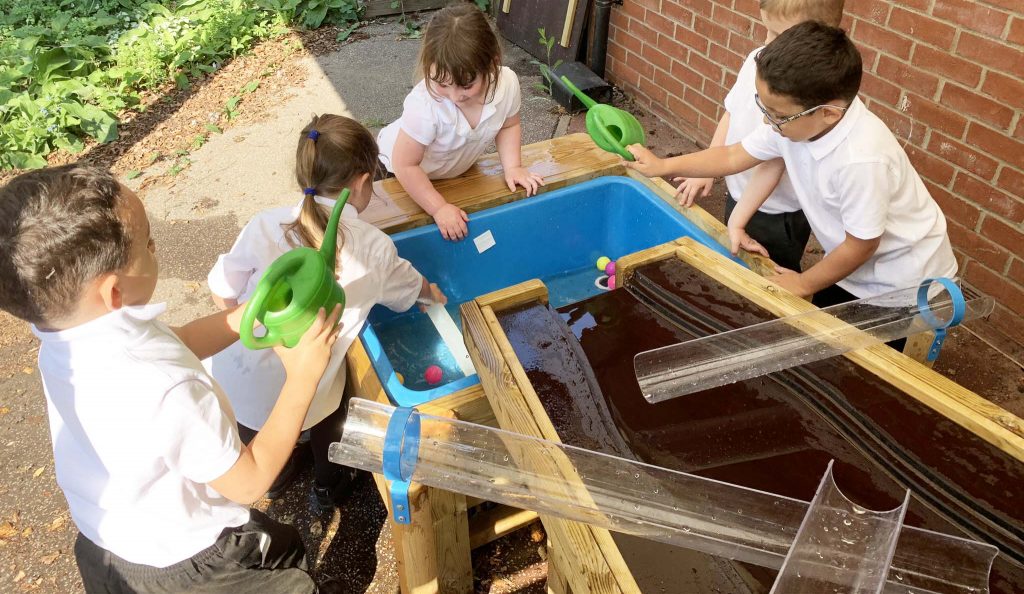 Photo of pupils enjoying wet play